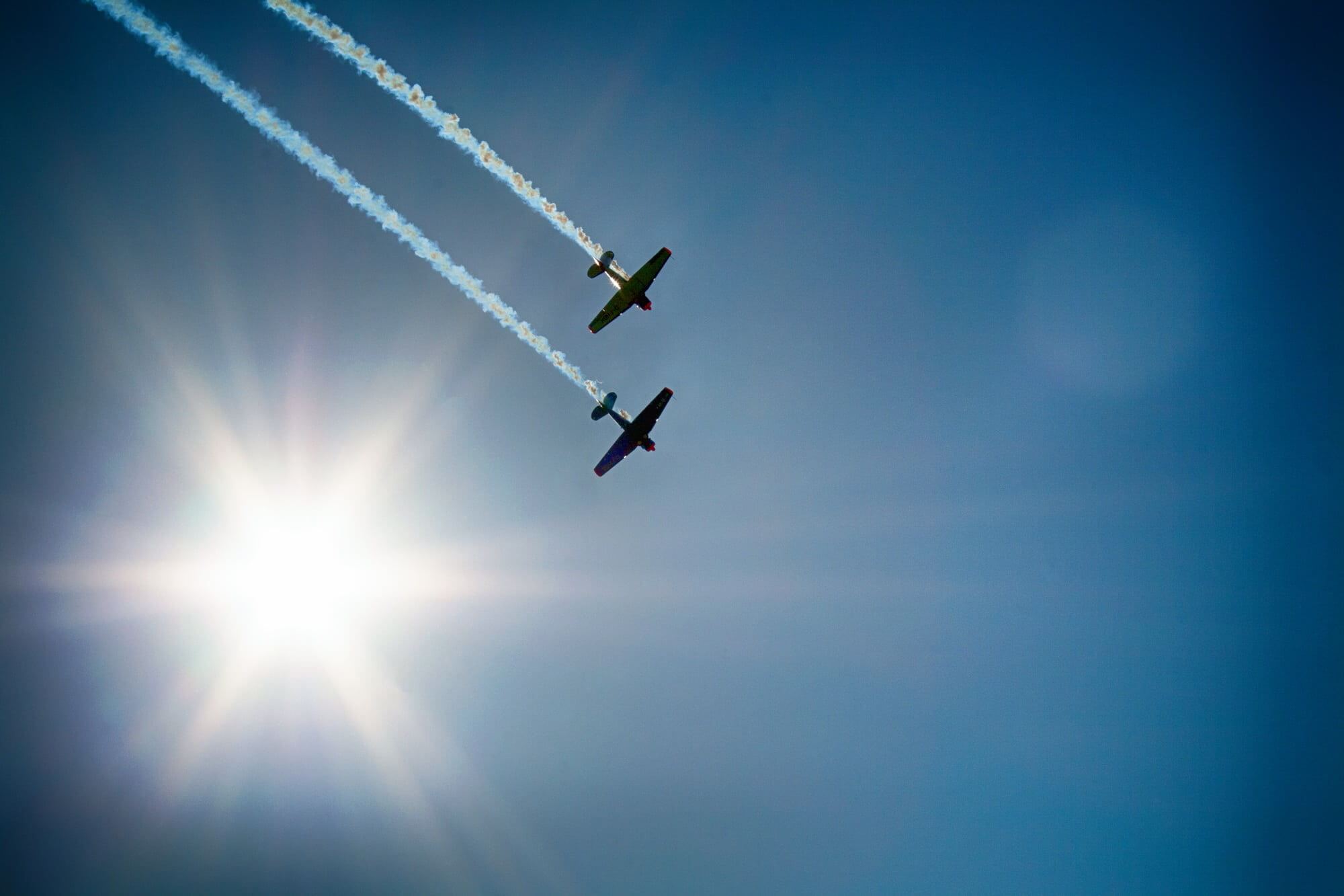 Two planes flying in tandem at air show